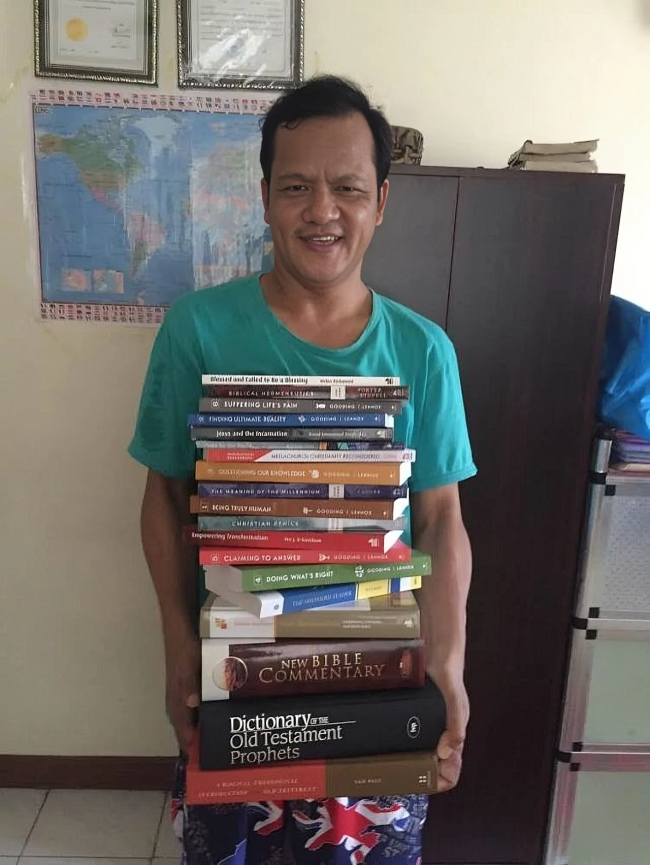 Student holding Langham books